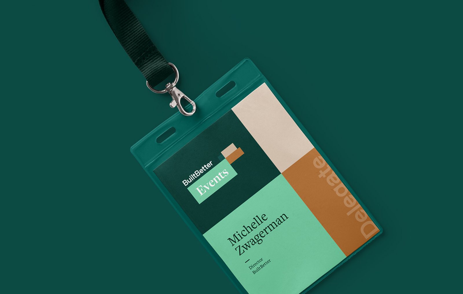 A conference name tag on a lanyard with the attendee name printed on it.