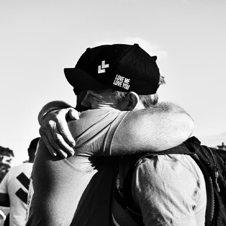 LMLY Instagram Post | Black and white image of two people hugging