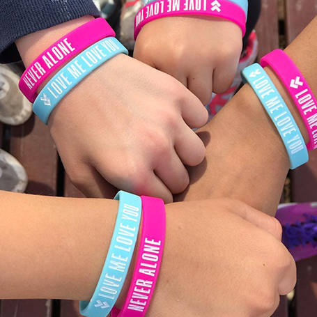 LMLY Instagram Post | 4 fists wearing blue and pink LMLY wristbands