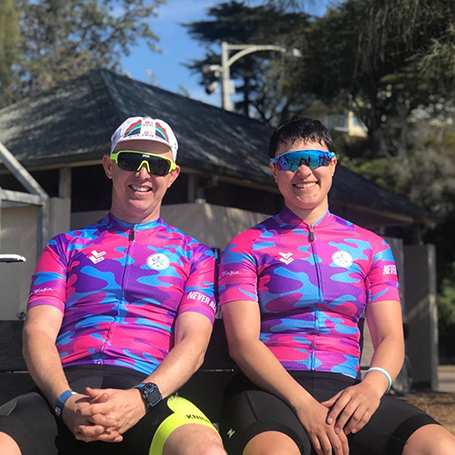 LMLY Instagram Post | Two male cyclists sitting side by side wearing Love Me Love You co-branded jerseys